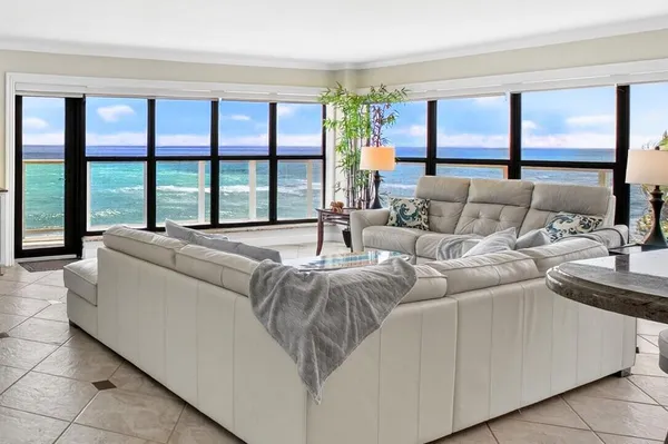 a living room with furniture and large windows