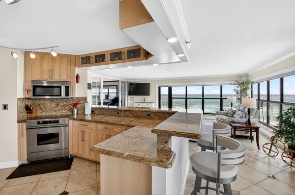 a kitchen with stainless steel appliances granite countertop a stove and white cabinets