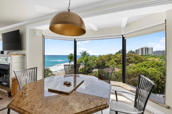 a living room with hardwood floor and a floor to ceiling window