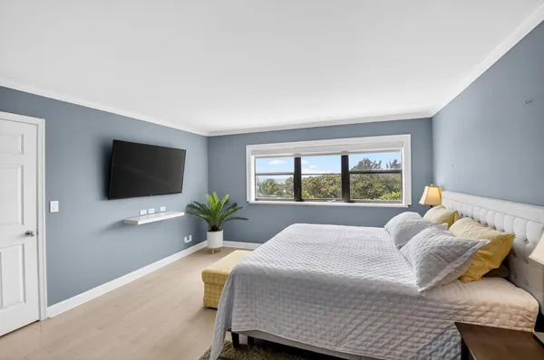 a bedroom with a large bed and a flat screen tv