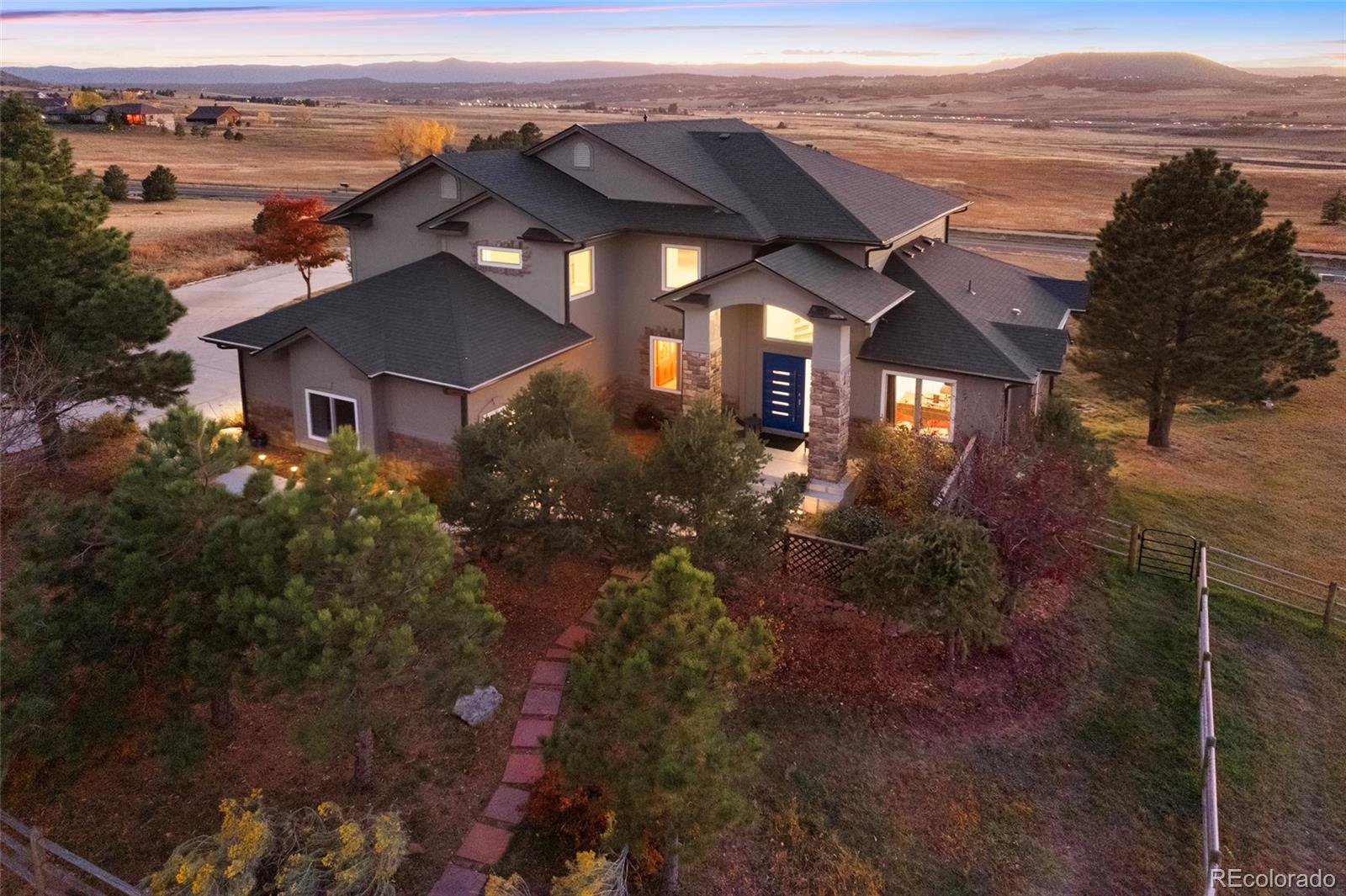 3532 Bell Mountain Drive Castle Rock, CO 80104 - Photo 1 of 50 an aerial view of a house with a yard lake and ocean view