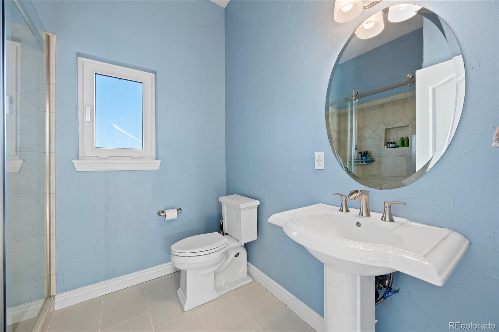 3532 Bell Mountain Drive Castle Rock, CO 80104 - Photo 20 of 50 a bathroom with a toilet a sink and mirror