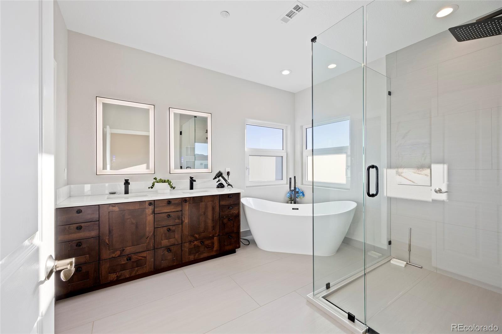3532 Bell Mountain Drive Castle Rock, CO 80104 - Photo 25 of 50 a spacious bathroom with a double vanity sink mirror and bathtub