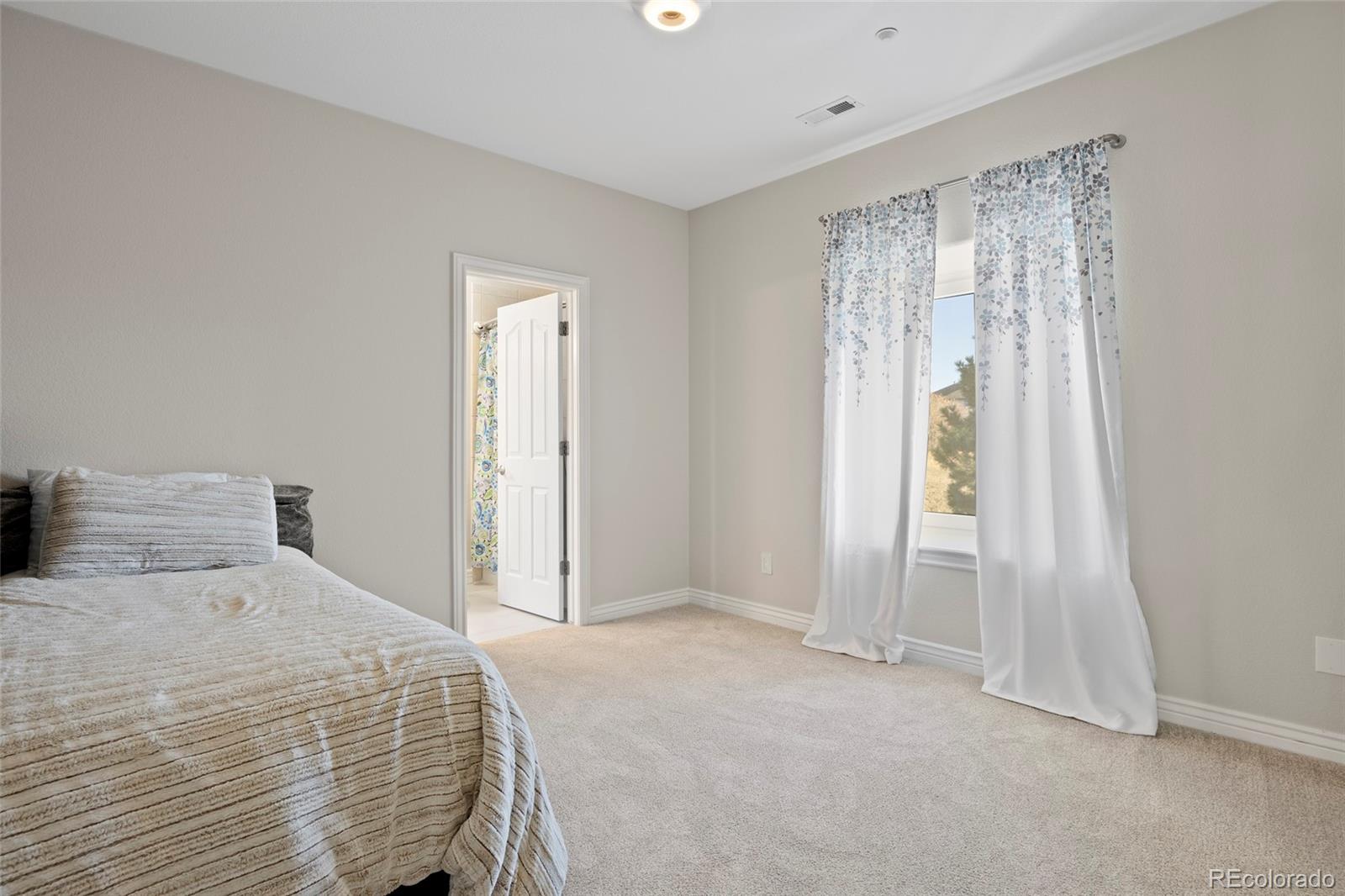 3532 Bell Mountain Drive Castle Rock, CO 80104 - Photo 31 of 50 a bedroom with a bed and a window