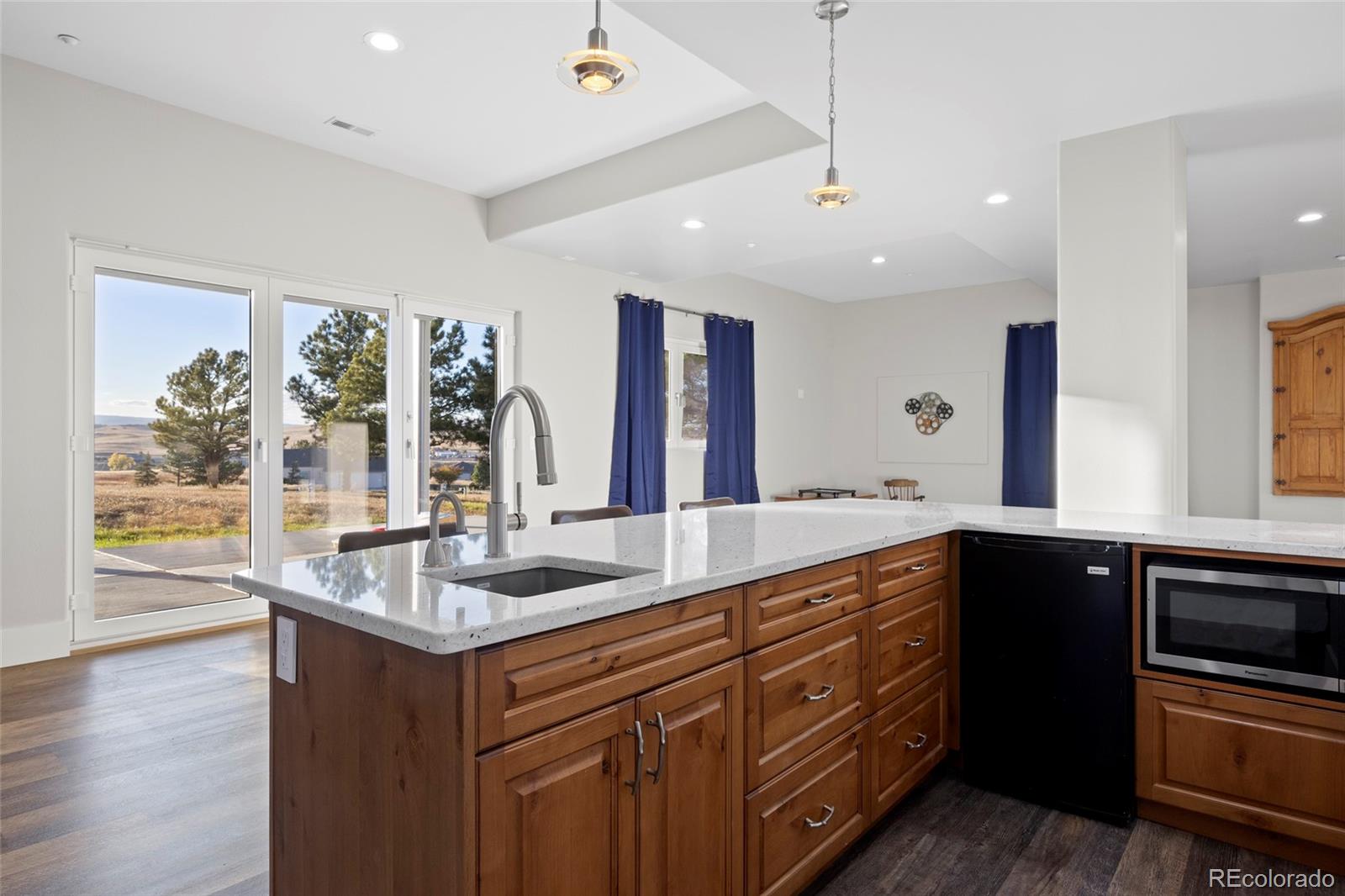 3532 Bell Mountain Drive Castle Rock, CO 80104 - Photo 36 of 50 a kitchen with stainless steel appliances granite countertop a sink and wooden cabinets