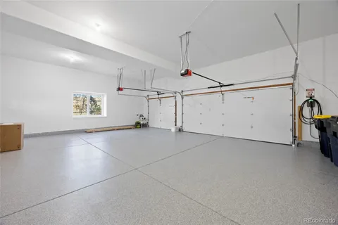 an aerial view of a house with a garden and lake view