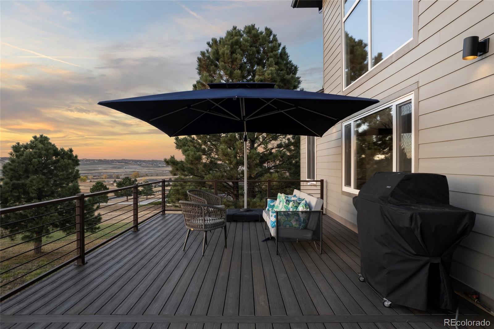 3532 Bell Mountain Drive Castle Rock, CO 80104 - Photo 4 of 50 a view of a roof deck with dining table and chairs with wooden floor