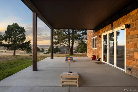 a view of a brick house with a bench and a yard