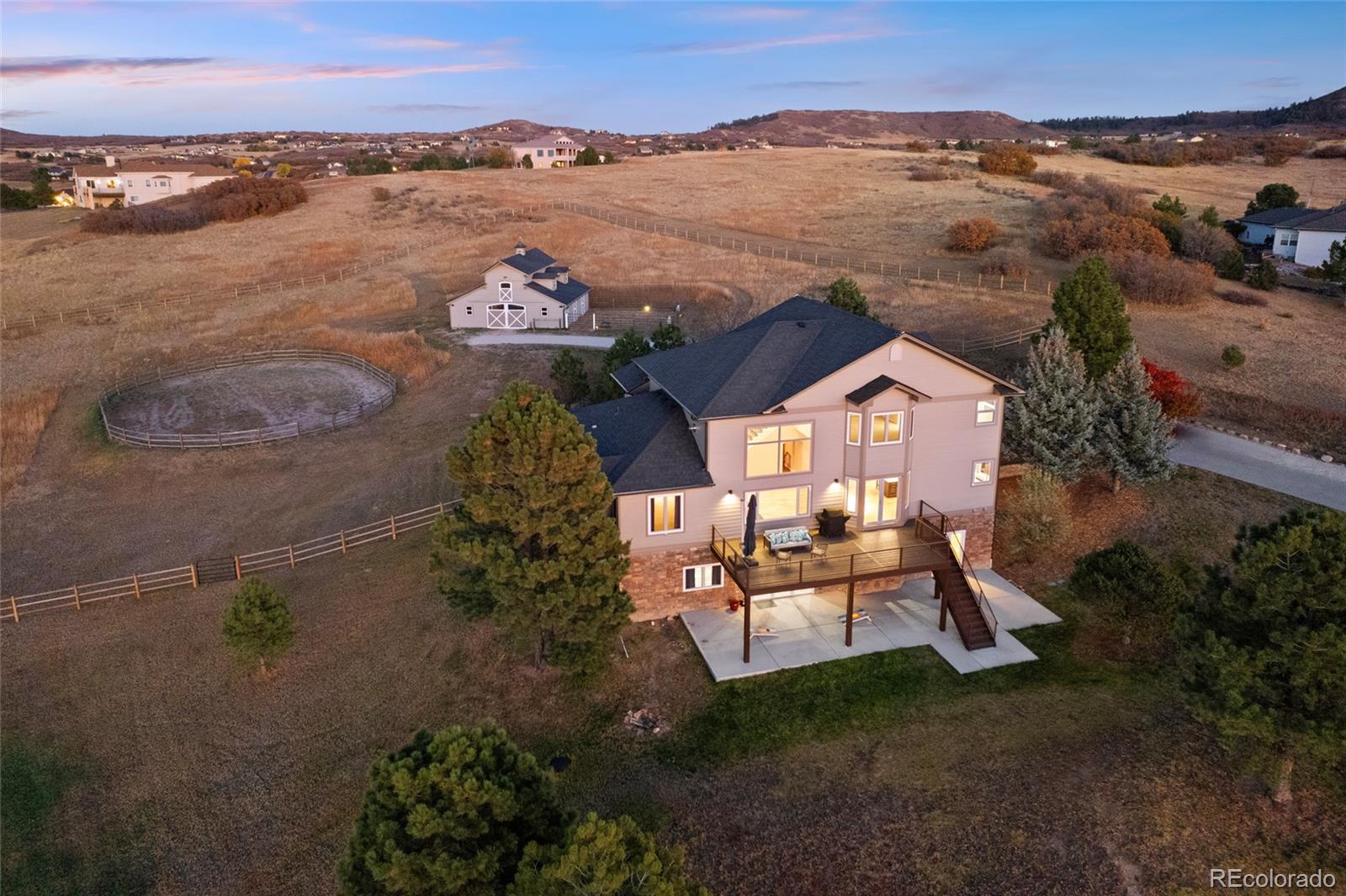 3532 Bell Mountain Drive Castle Rock, CO 80104 - Photo 44 of 50 an aerial view of a house with a garden and lake view