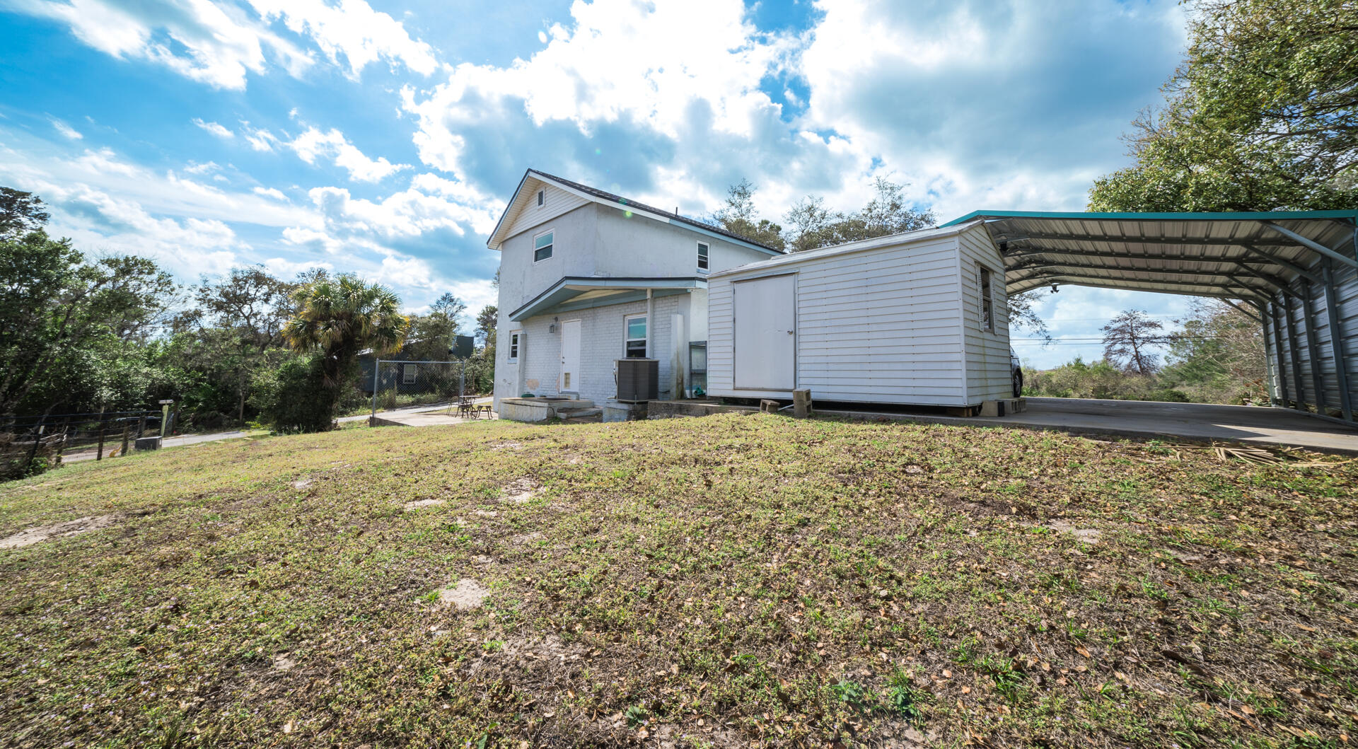 2289 Holder Road Mims, FL 32754 - Photo 17 of 17 a backyard of a house with large trees