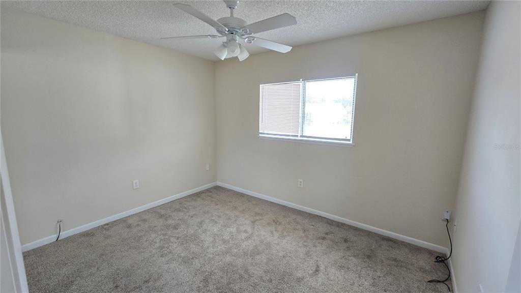 11239 Southwest 77th Court Ocala, FL 34476 - Photo 14 of 22 an empty room with a window and a fan