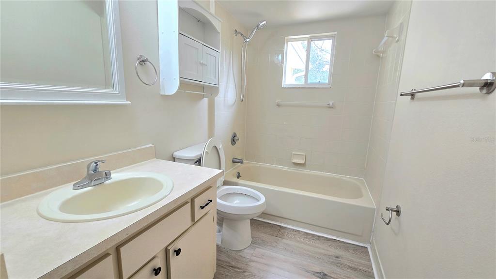 11239 Southwest 77th Court Ocala, FL 34476 - Photo 16 of 22 a bathroom with a sink toilet and a bathtub
