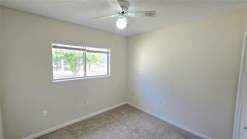 11239 Southwest 77th Court Ocala, FL 34476 - Photo 17 of 22 an empty room with a window and a fan