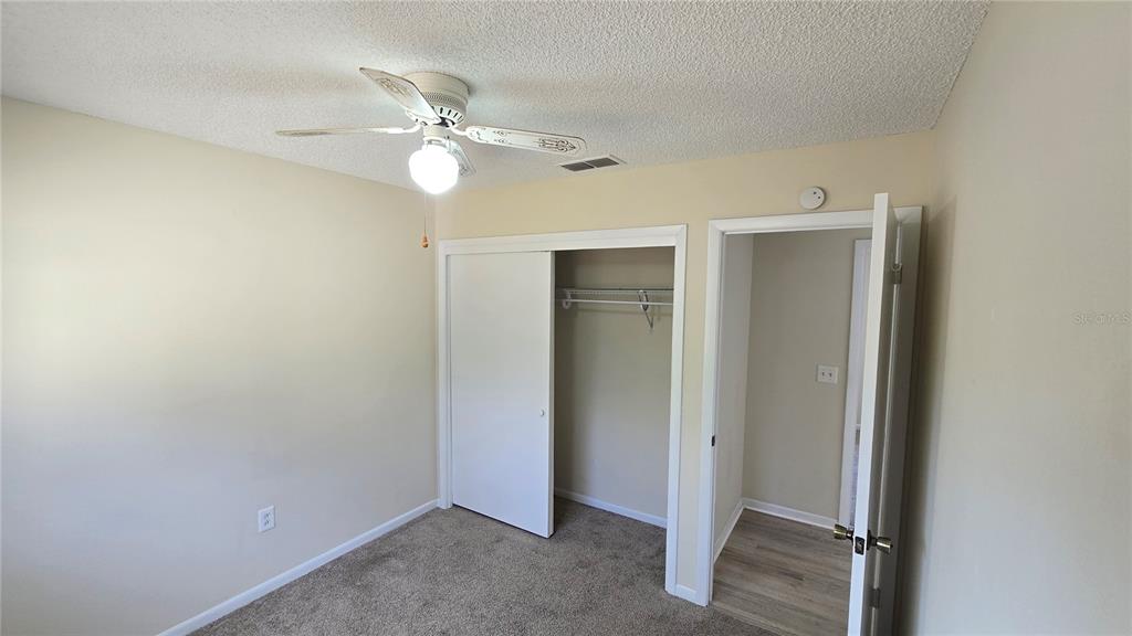11239 Southwest 77th Court Ocala, FL 34476 - Photo 18 of 22 an empty room with fan and entrance