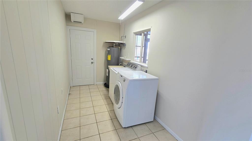 11239 Southwest 77th Court Ocala, FL 34476 - Photo 19 of 22 a utility room with dryer and washer