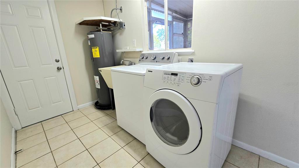 11239 Southwest 77th Court Ocala, FL 34476 - Photo 20 of 22 a utility room with dryer and washer