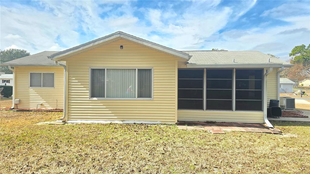 11239 Southwest 77th Court Ocala, FL 34476 - Photo 22 of 22 a front view of a house with a yard