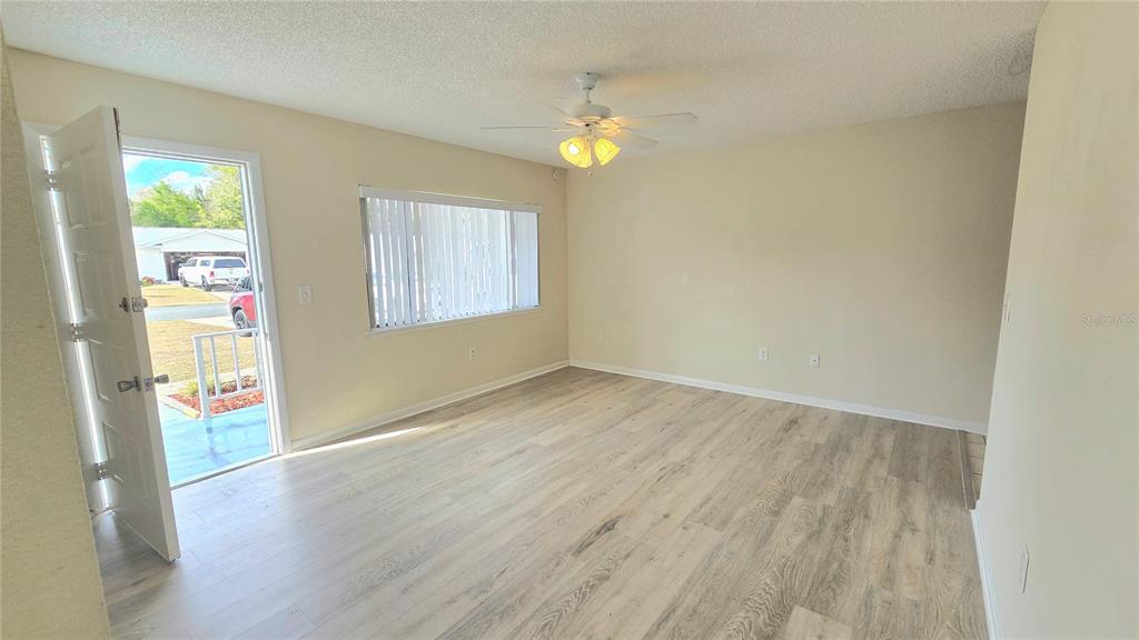11239 Southwest 77th Court Ocala, FL 34476 - Photo 4 of 22 a view of livingroom with hardwood floor and hallway