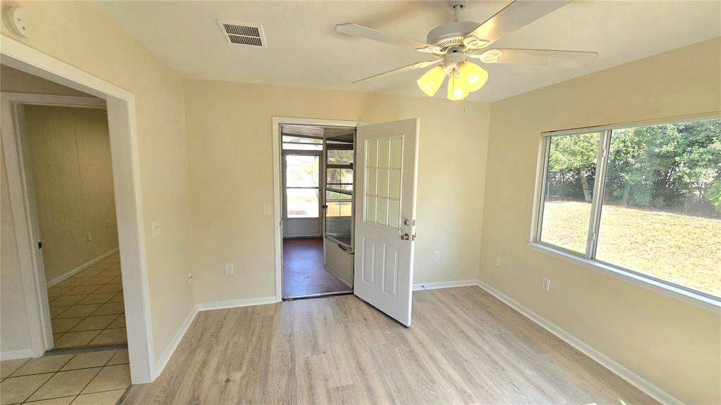 11239 Southwest 77th Court Ocala, FL 34476 - Photo 7 of 22 wooden floor in an empty room with a window