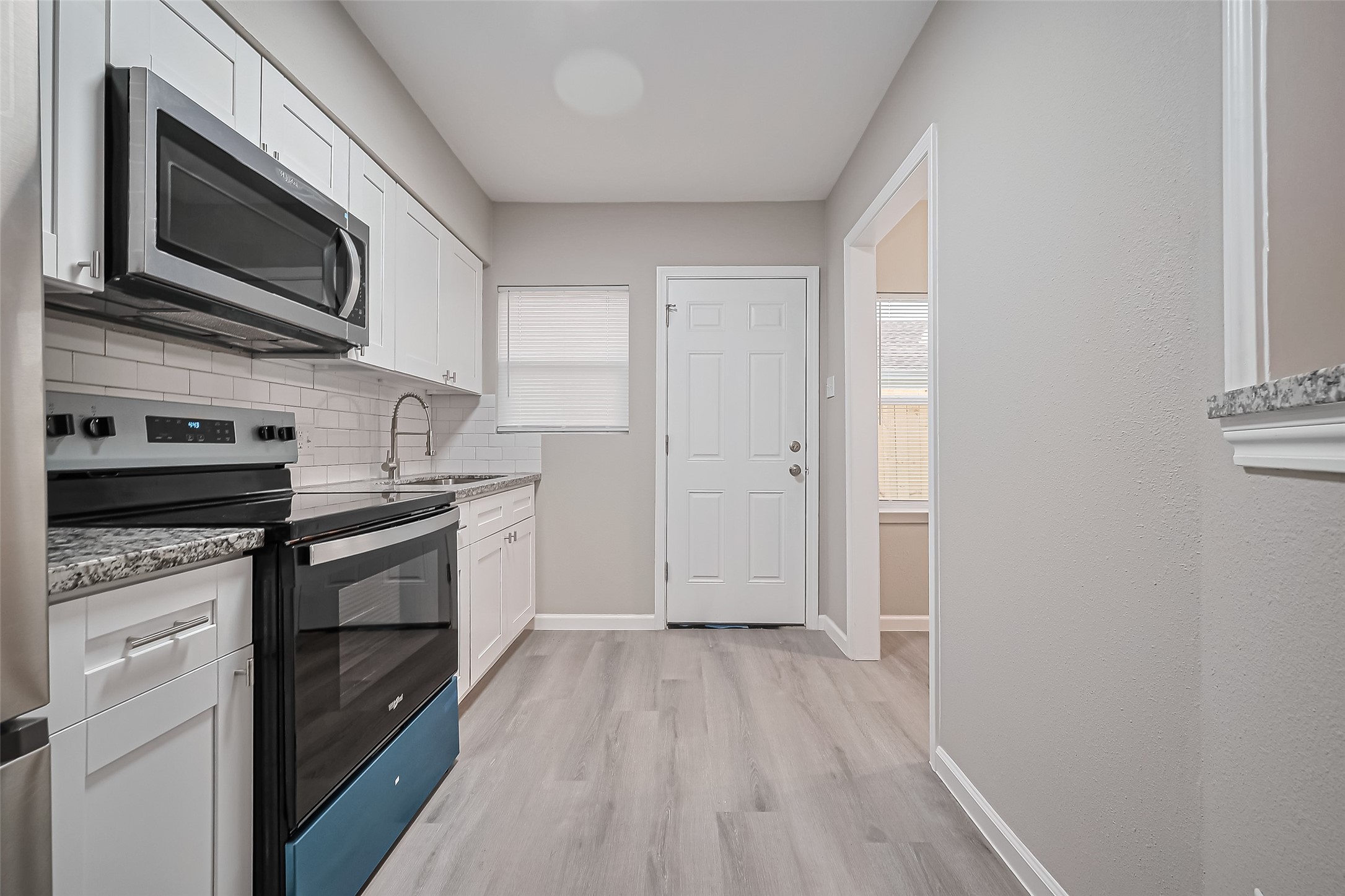 1739-17 West 5th Street Freeport, TX 77541 - Photo 11 of 26 a kitchen with stainless steel appliances granite countertop a stove microwave and sink