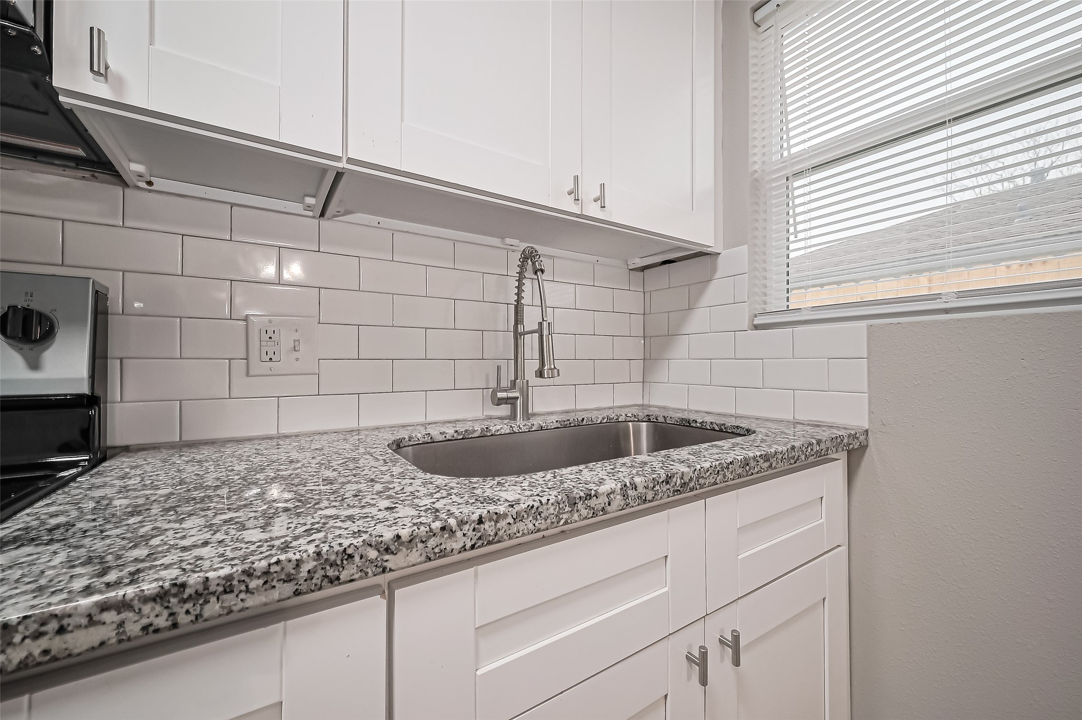 1739-17 West 5th Street Freeport, TX 77541 - Photo 12 of 26 a bathroom with a granite countertop sink and vanity