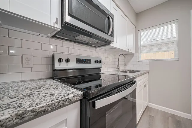 a kitchen stove top oven sitting inside of a kitchen