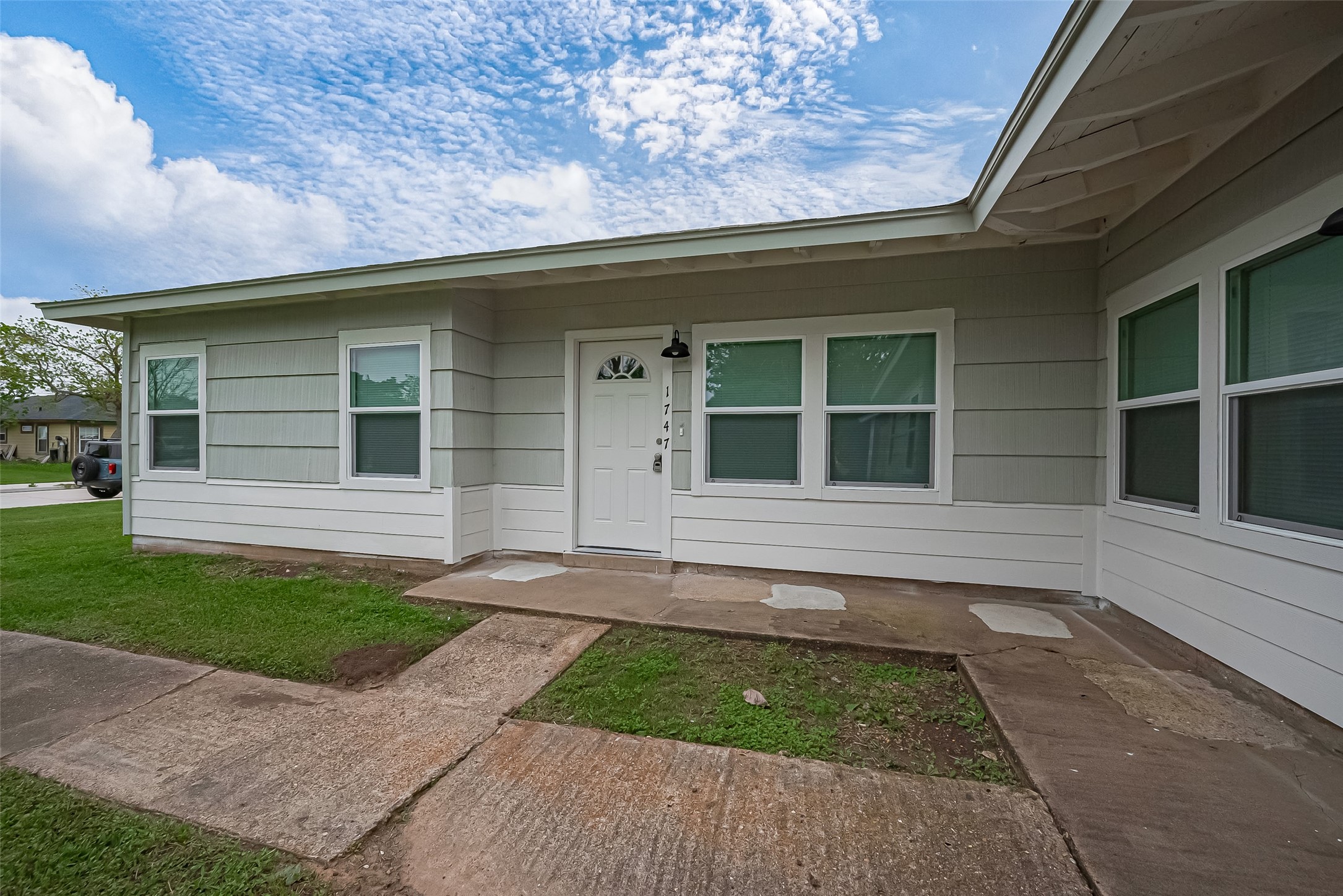 1739-17 West 5th Street Freeport, TX 77541 - Photo 2 of 26 a front view of a house with garage