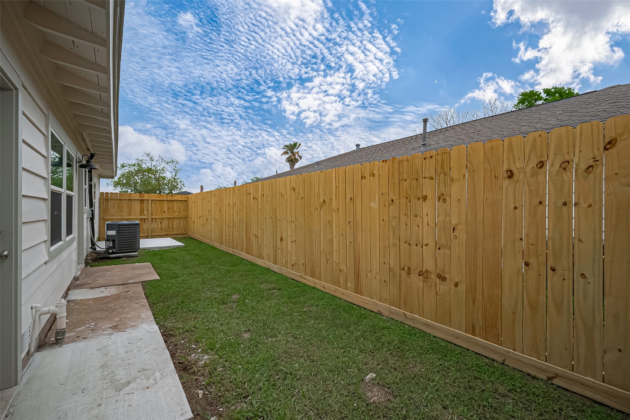 1739-17 West 5th Street Freeport, TX 77541 - Photo 26 of 26 a view of a back yard with wooden fence