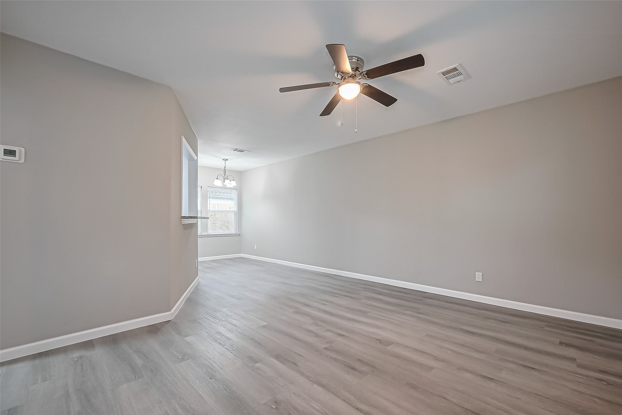 1739-17 West 5th Street Freeport, TX 77541 - Photo 5 of 26 a view of an empty room with wooden floor and a window