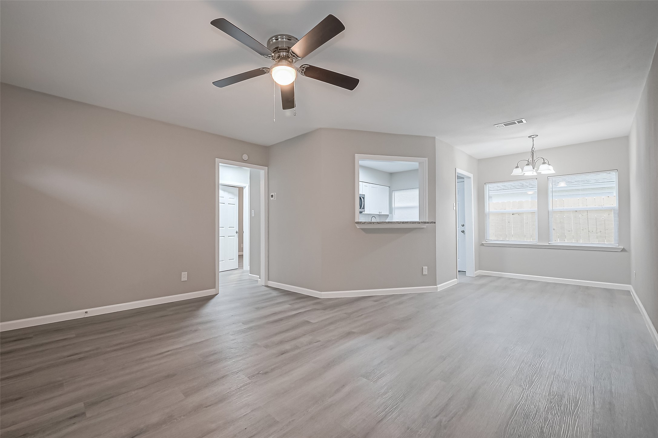 1739-17 West 5th Street Freeport, TX 77541 - Photo 6 of 26 an empty room with wooden floor and windows