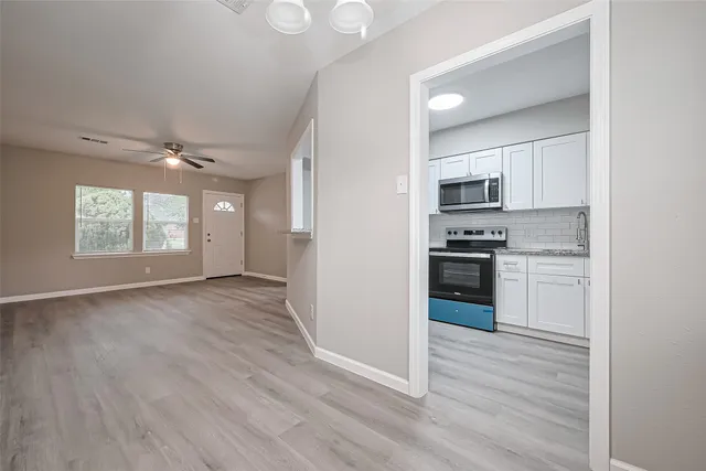 a kitchen with stainless steel appliances a refrigerator and a stove top oven