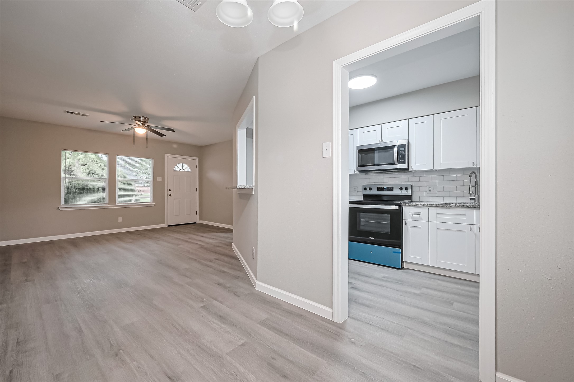 1739-17 West 5th Street Freeport, TX 77541 - Photo 7 of 26 a kitchen with stainless steel appliances a refrigerator and a stove top oven