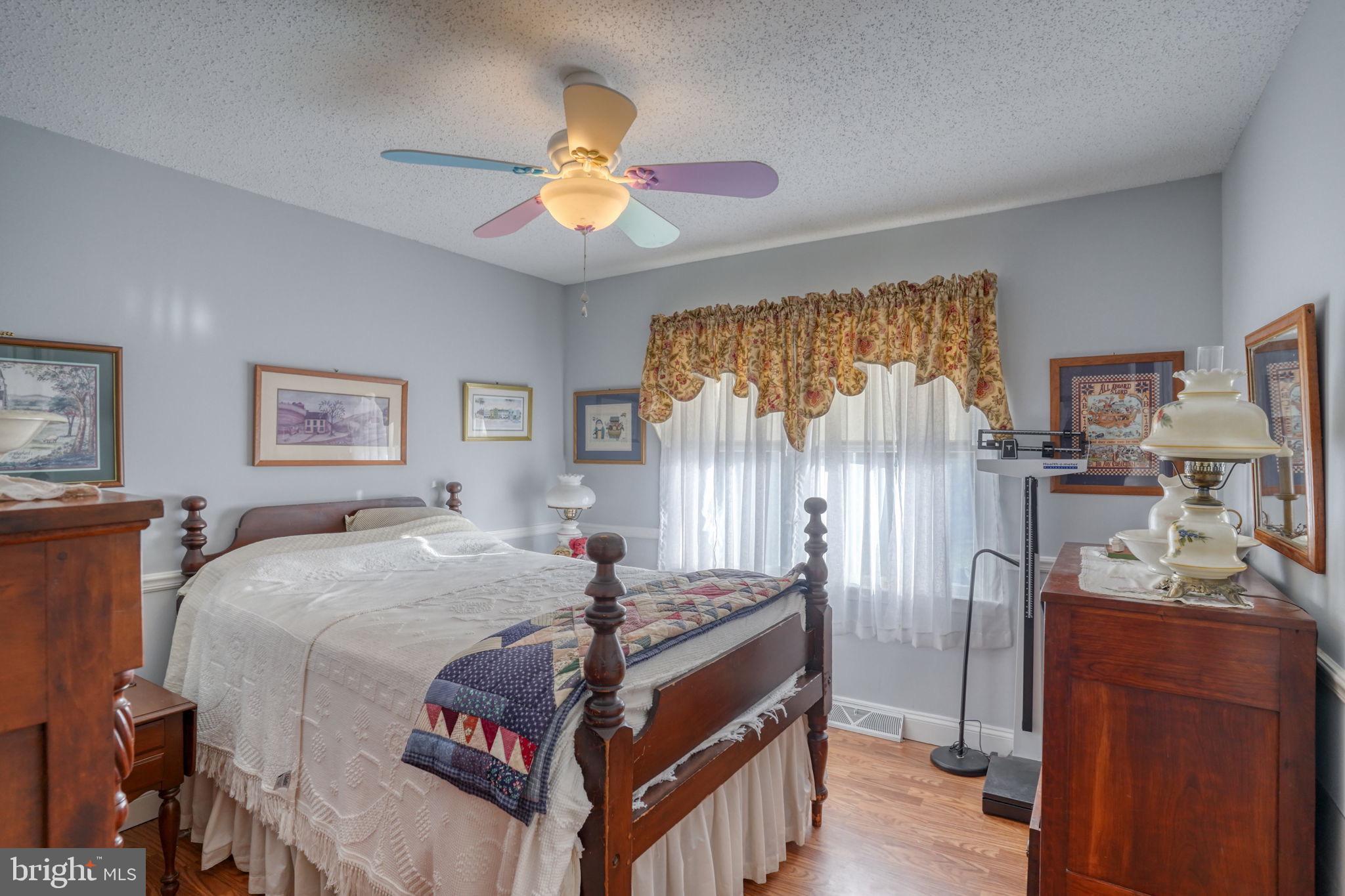 1406 Turkey Point Road Felton, DE 19943 - Photo 16 of 24 a bedroom with a bed and a chandelier
