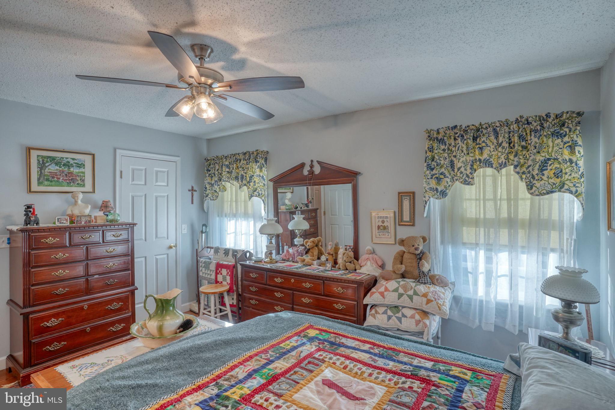 1406 Turkey Point Road Felton, DE 19943 - Photo 20 of 24 a bedroom with a bed and a chandelier