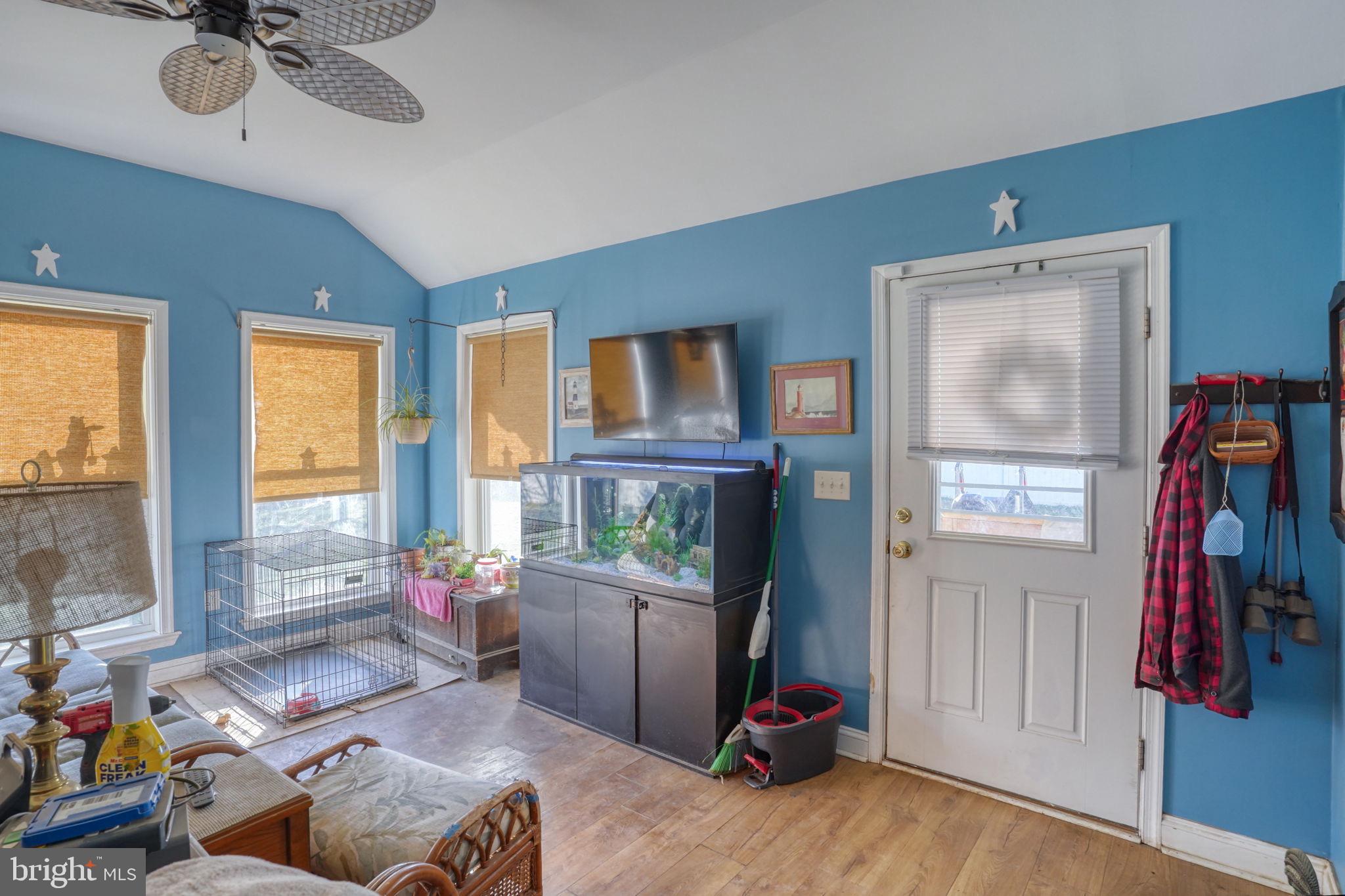 1406 Turkey Point Road Felton, DE 19943 - Photo 21 of 24 a living room with furniture a flat screen tv and a window