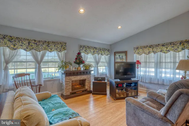 a living room with furniture a fireplace and a flat screen tv