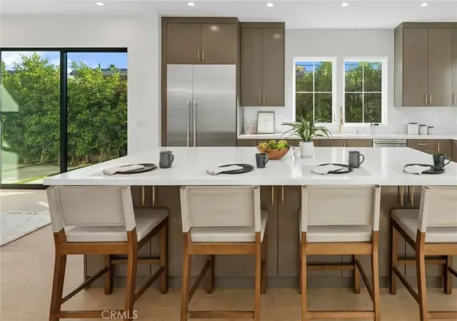 a kitchen with a table chairs stove and cabinets
