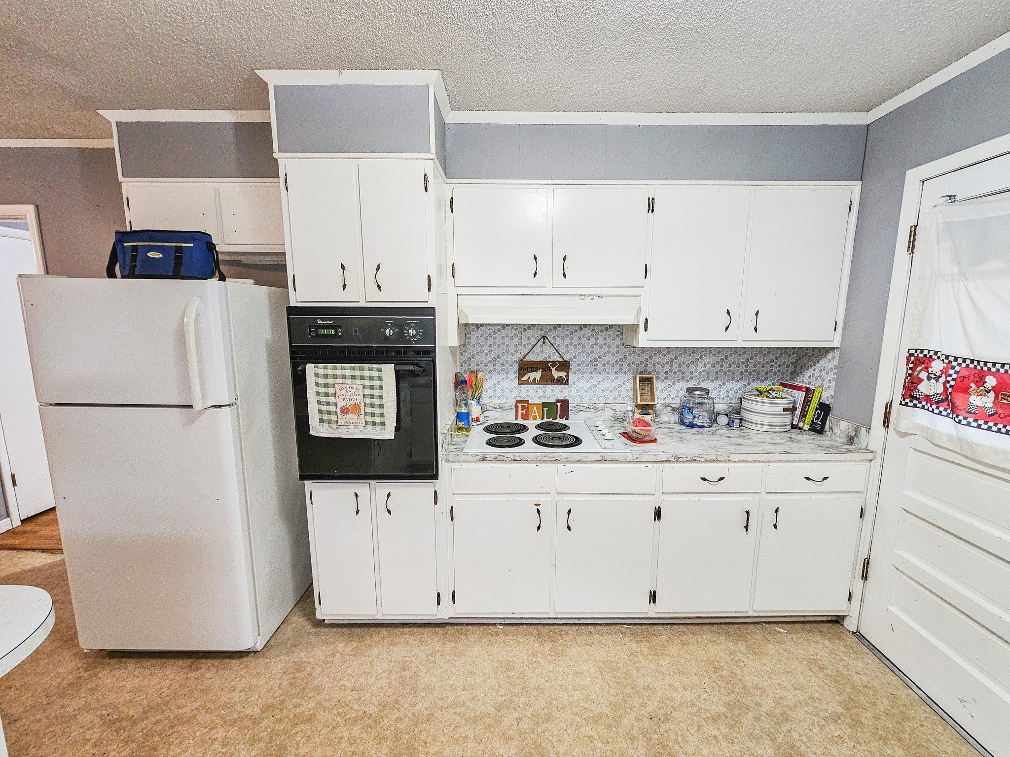 495 Salem Road Minor Hill, TN 38473 - Photo 14 of 30 a kitchen with granite countertop a refrigerator a stove a sink and white cabinets