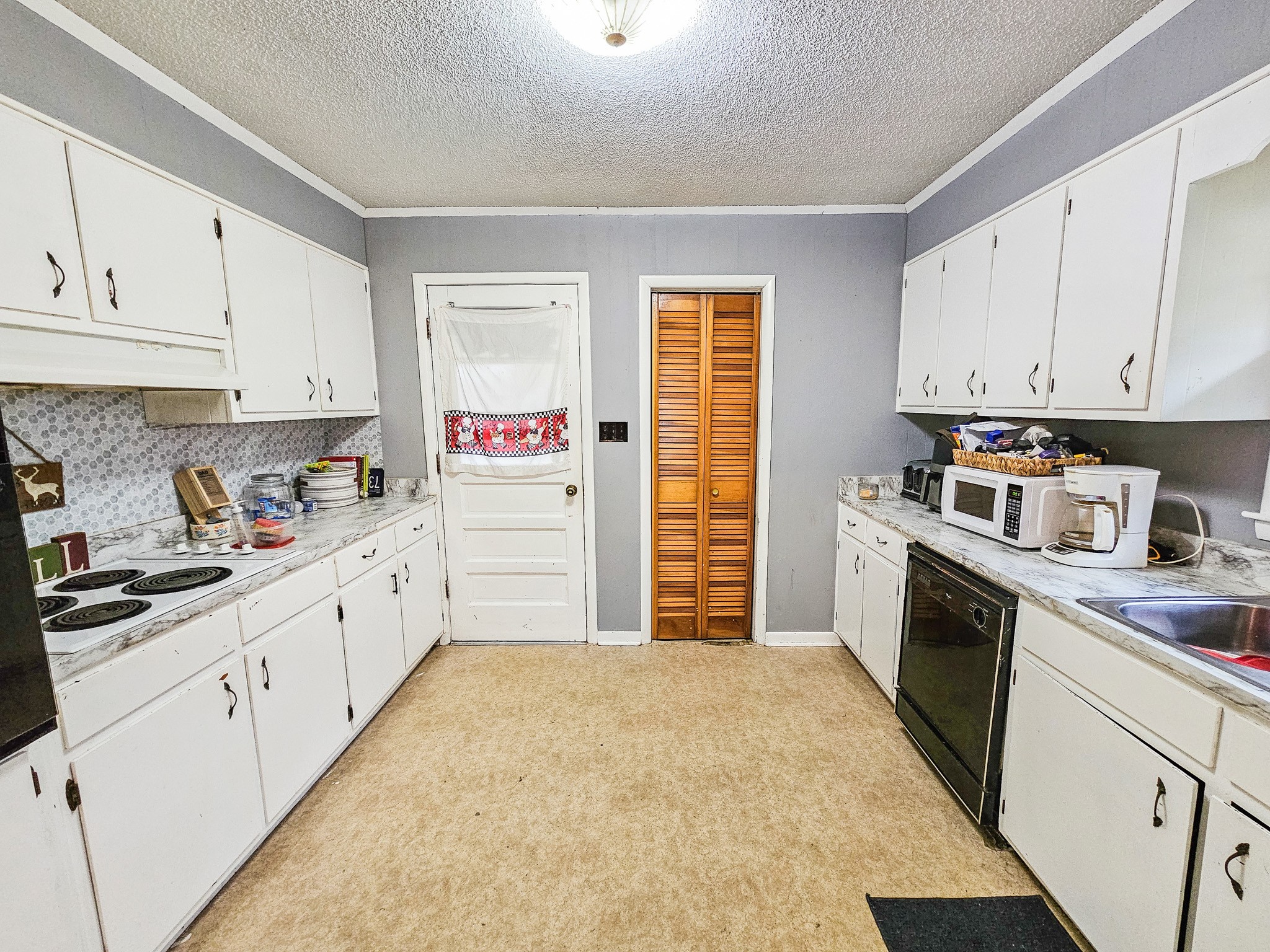 495 Salem Road Minor Hill, TN 38473 - Photo 17 of 30 a kitchen with stainless steel appliances granite countertop a sink and cabinets with wooden floor