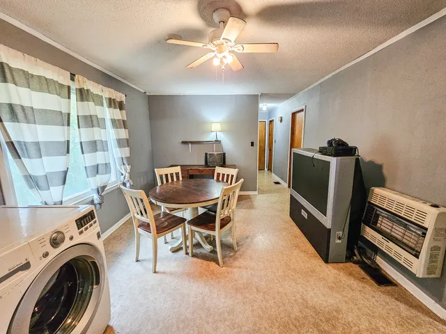 a dining room with furniture and window