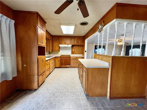 a kitchen with stainless steel appliances granite countertop a refrigerator and a stove