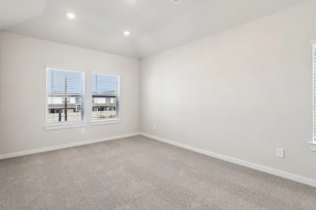 a bedroom with a bed and a potted plant