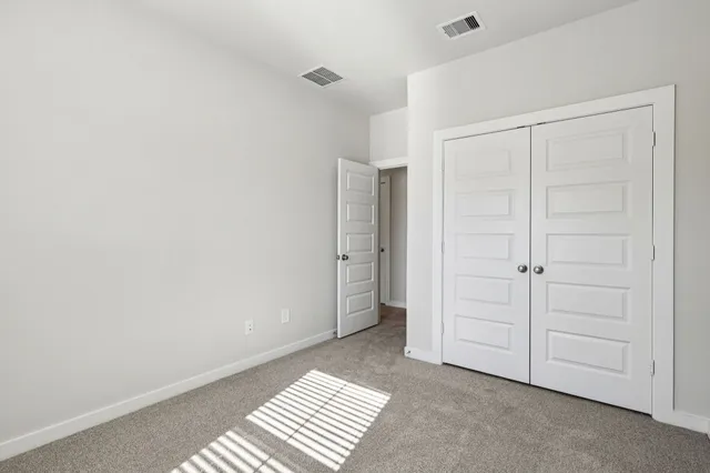 a bedroom with a bed and a potted plant