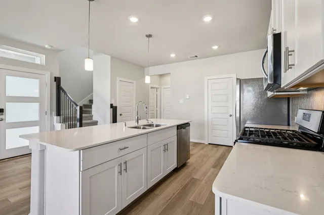 a kitchen with counter top space appliances and cabinets
