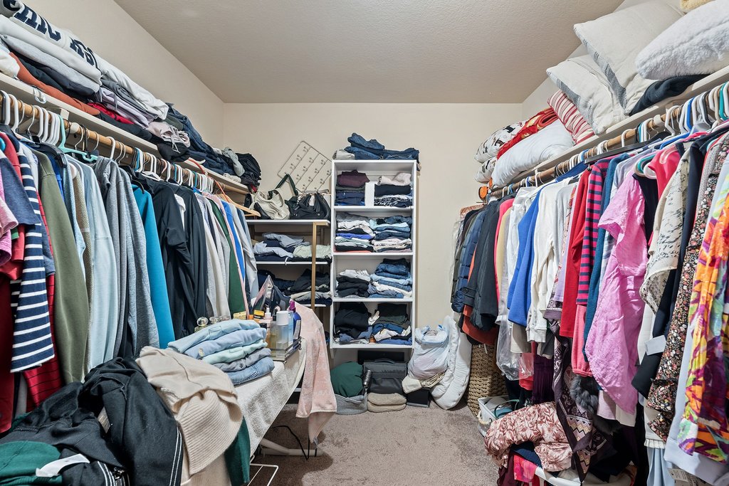 140 Wolfberry Path Buda, TX 78610 - Photo 31 of 35 a view of walk in closet with clothes and shoes
