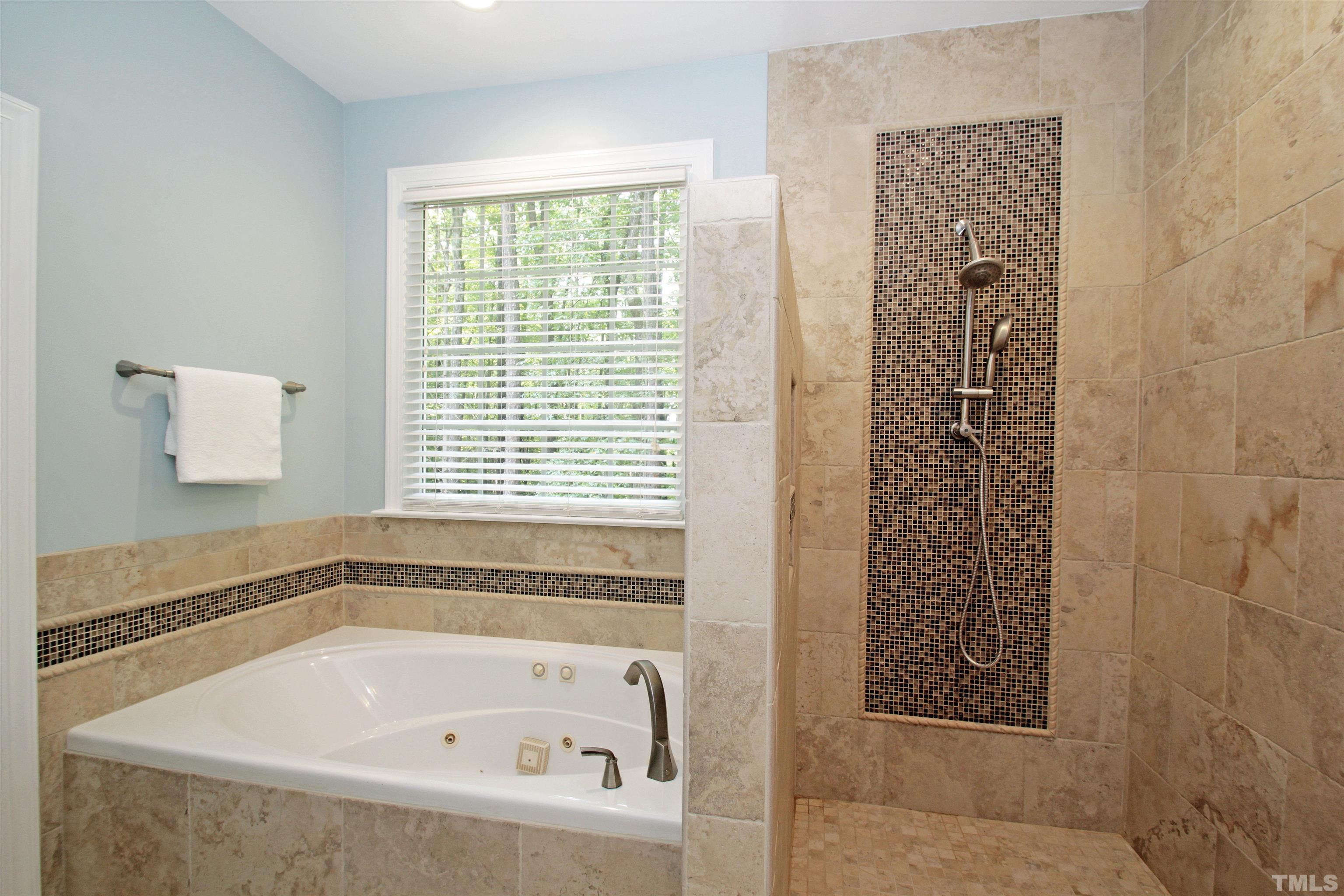 11817 Mountbatten Way Raleigh, NC 27613 - Photo 14 of 28 a white bath tub sitting next to a window