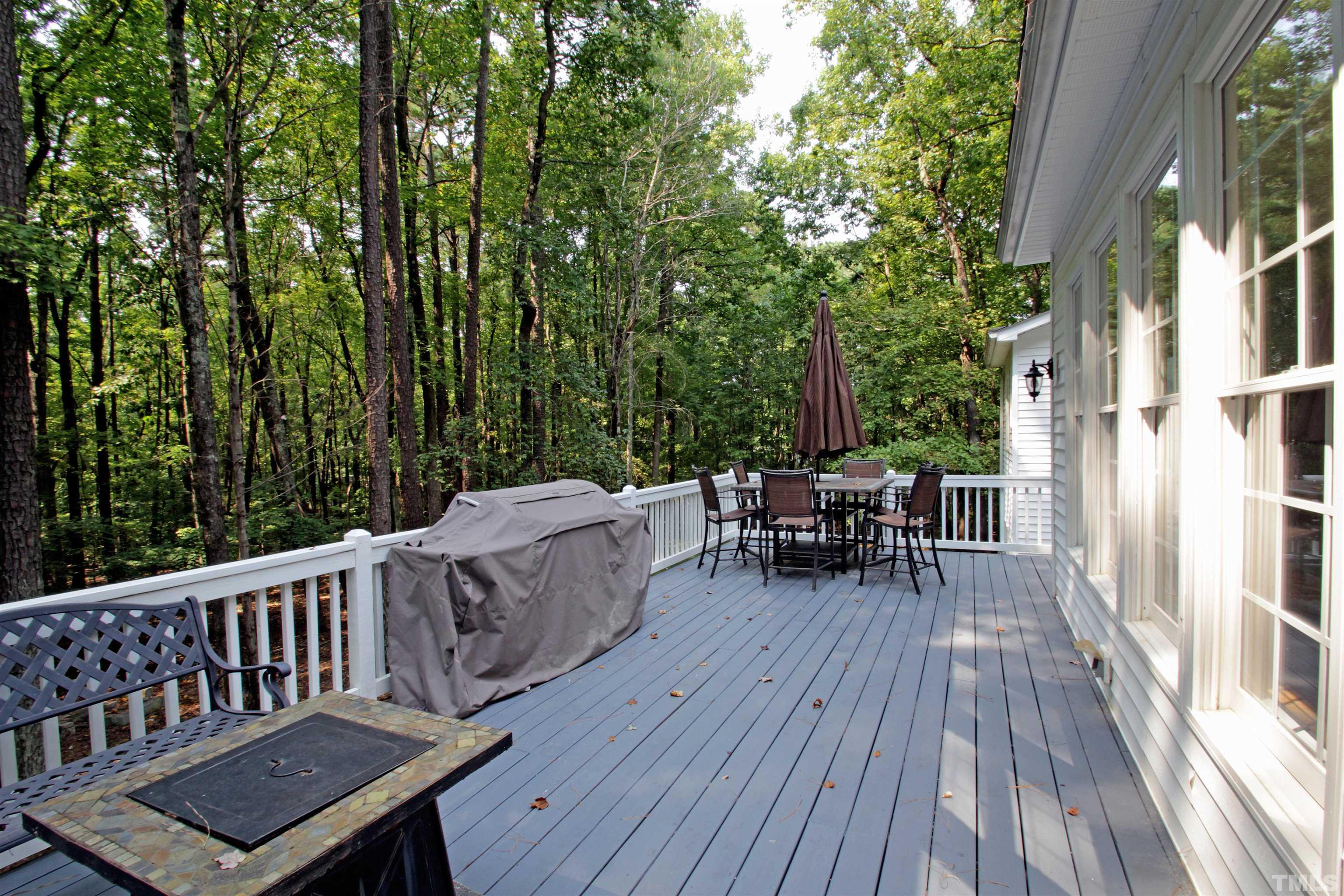 11817 Mountbatten Way Raleigh, NC 27613 - Photo 3 of 28 a view of a deck with table and chairs and wooden floor