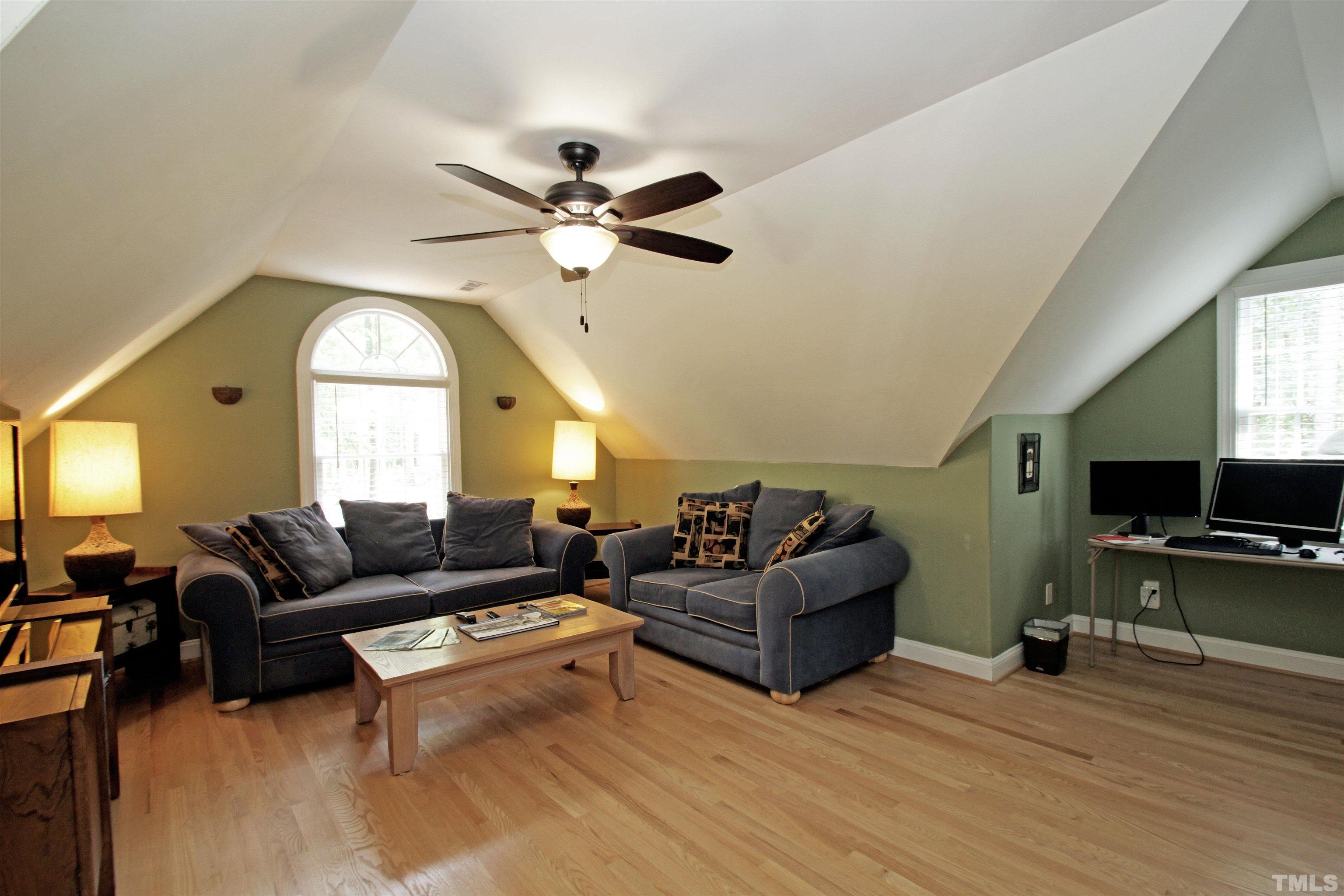 11817 Mountbatten Way Raleigh, NC 27613 - Photo 22 of 28 a living room with furniture a ceiling fan a fireplace and a window