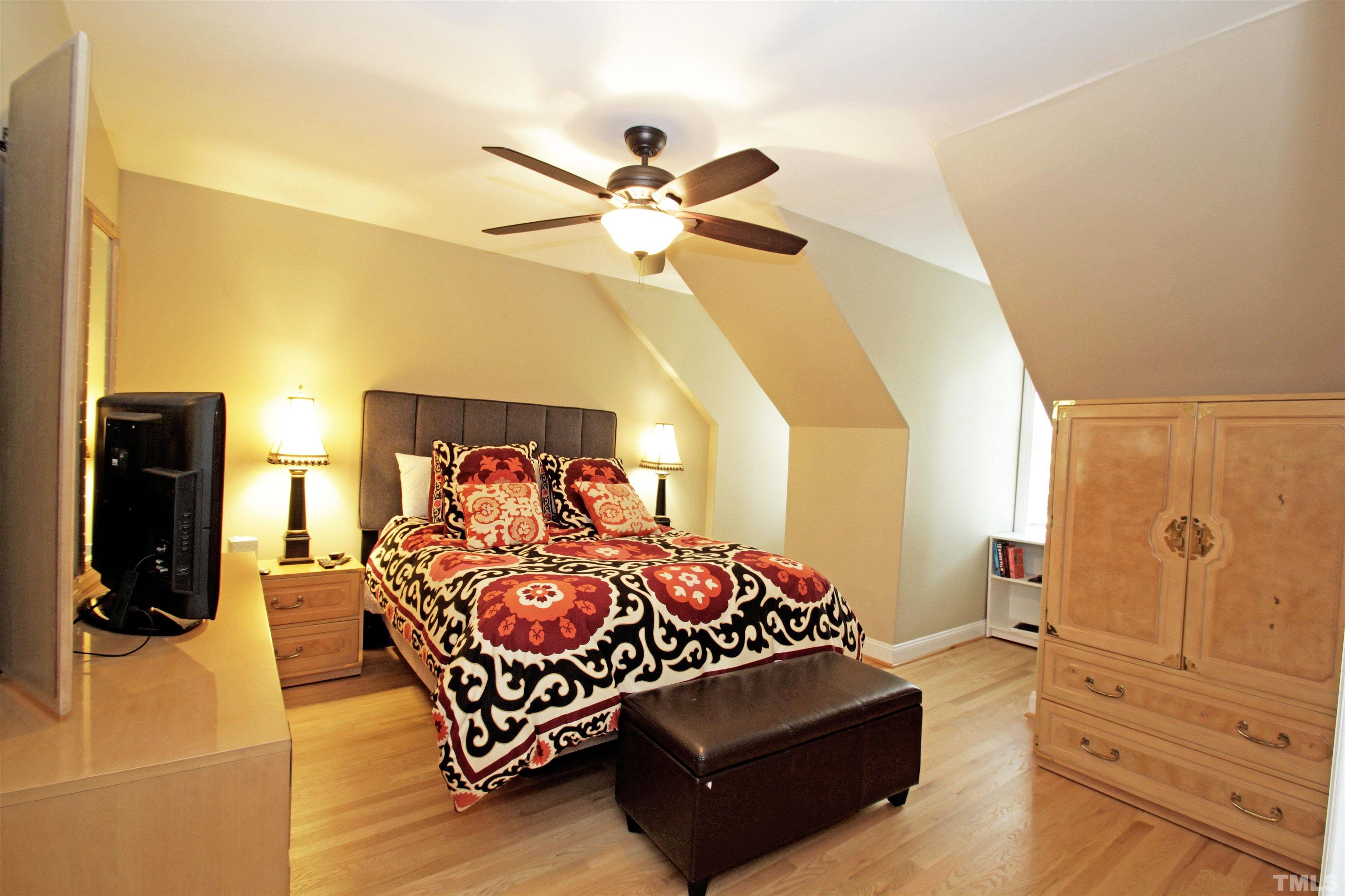 11817 Mountbatten Way Raleigh, NC 27613 - Photo 23 of 28 a bedroom with a bed and wooden floor