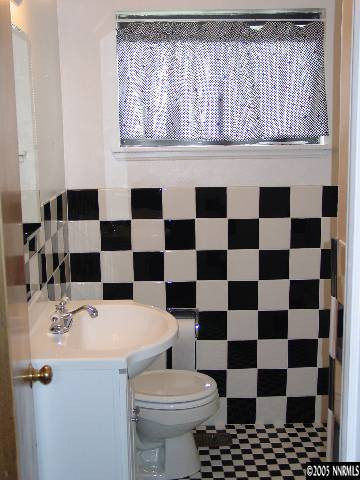 795 Bowman Drive Reno, NV 89503 - Photo 4 of 9 a bathroom with a sink a toilet and a mirror